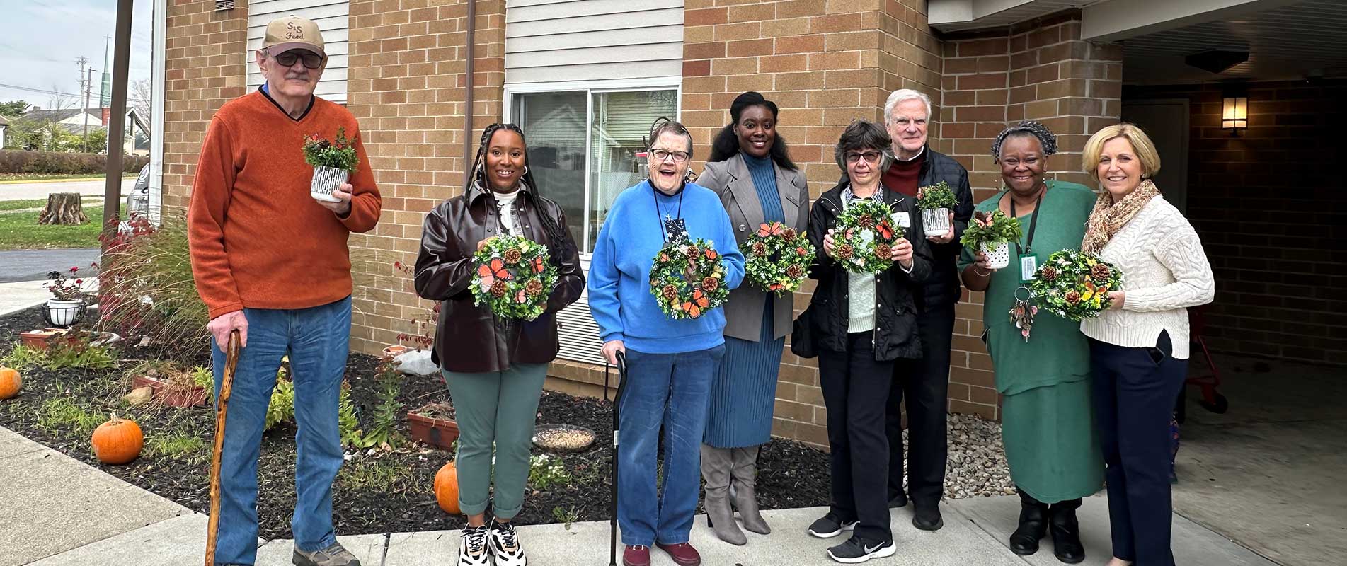 group photo of residents with plants