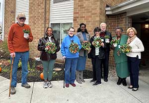 group photo of residents with plants